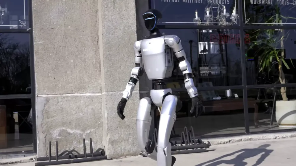 A factory video shows a Unitree robot behaving erratically, almost injuring workers